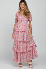 woman wearing a pink floral maternity maxi dress with tiered ruffles and short puff sleeves