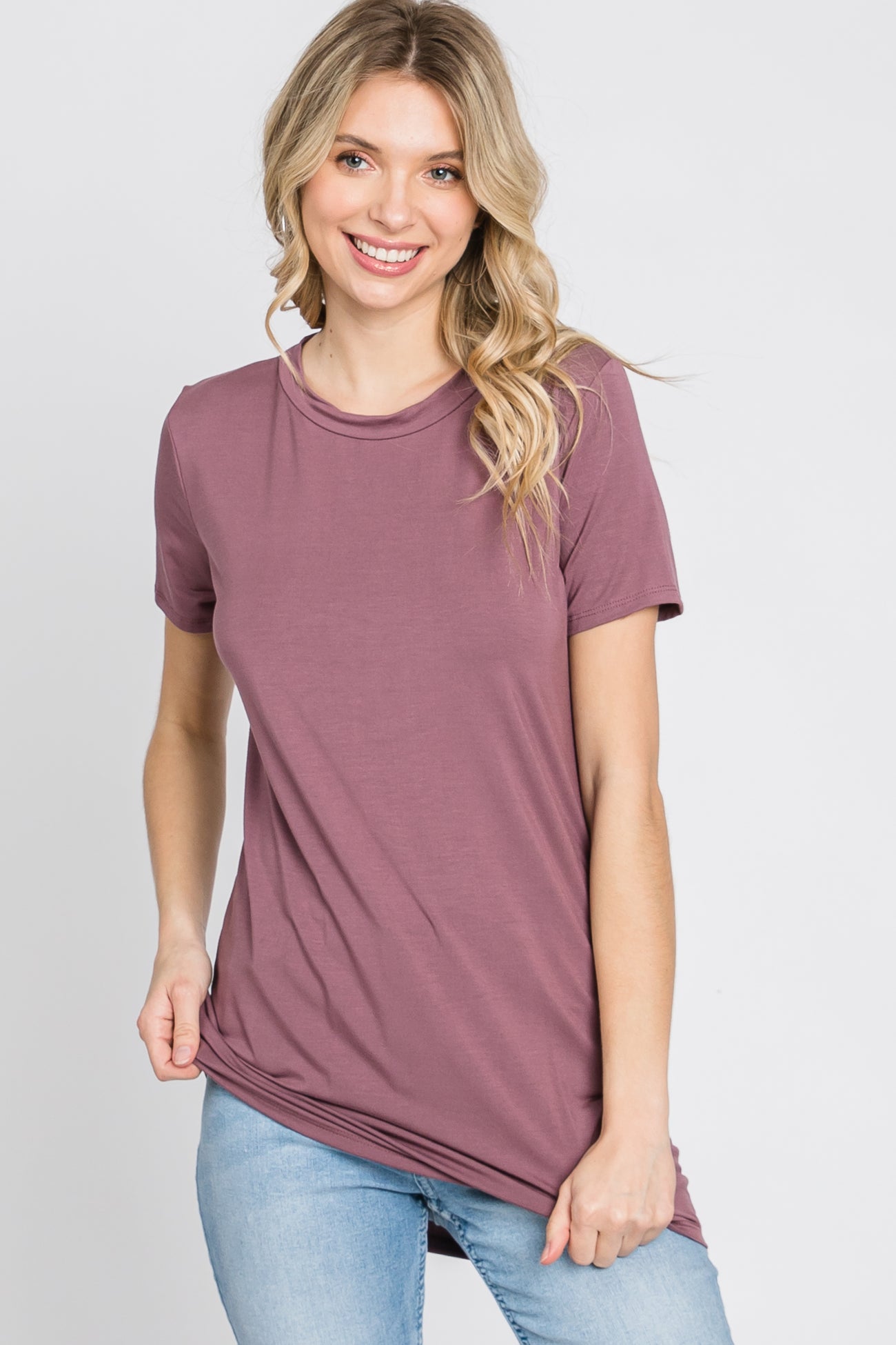 woman wearing a mauve short sleeve t-shirt with a relaxed fit and round neckline