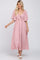 woman wearing a light pink maxi dress with flutter sleeves and a tie-front detail