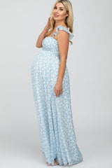 pregnant woman in light blue floral smocked maternity maxi dress with ruffle sleeves