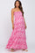 woman wearing a pink floral strapless maxi maternity dress with a fitted bodice and flowy skirt