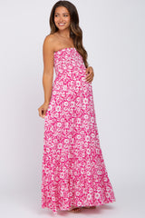 woman wearing a pink floral strapless maxi dress and holding her baby bump
