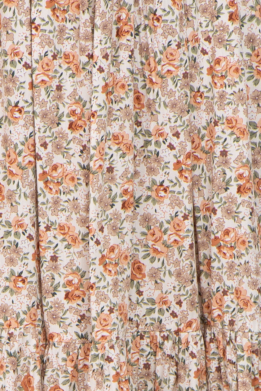 floral print fabric in soft peach and beige hues with gathered ruffle detailing