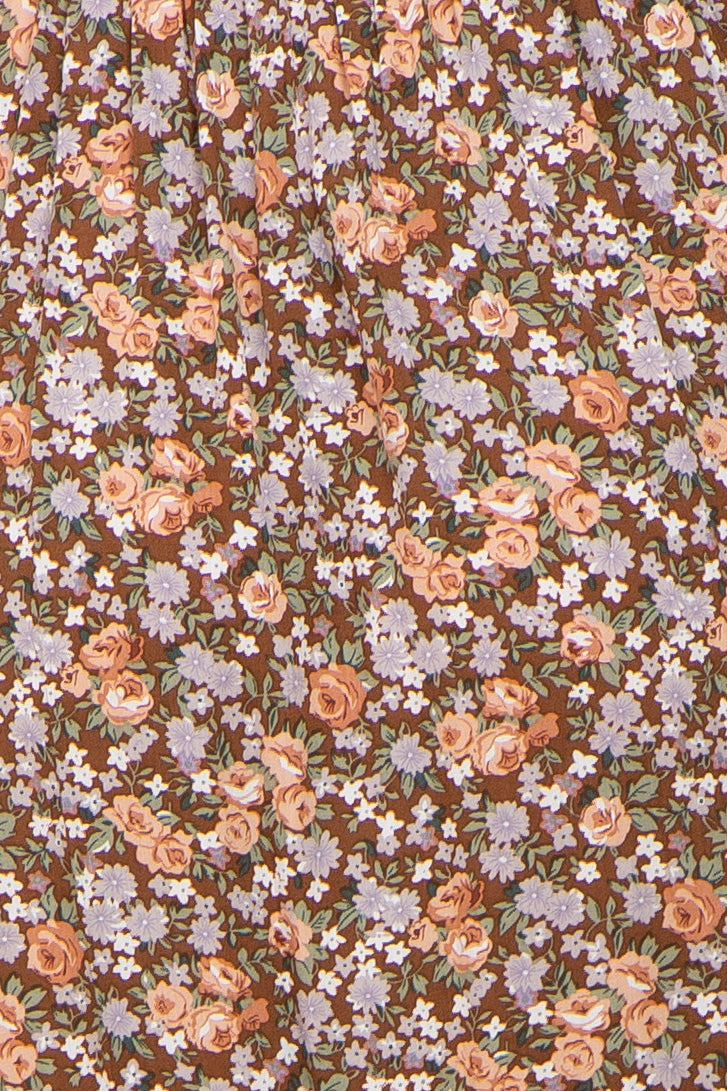 close-up of brown floral print maternity fabric with pink and lavender flowers