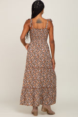 woman wearing a brown floral maxi dress with ruffled straps and a smocked back view