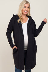 woman wearing a black maternity hoodie cardigan and showing her baby bump