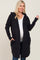 woman wearing a black maternity hoodie cardigan and showing her baby bump