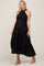 woman wearing a black pleated maternity dress with a halter neckline and adjustable tie, highlighting her baby bump