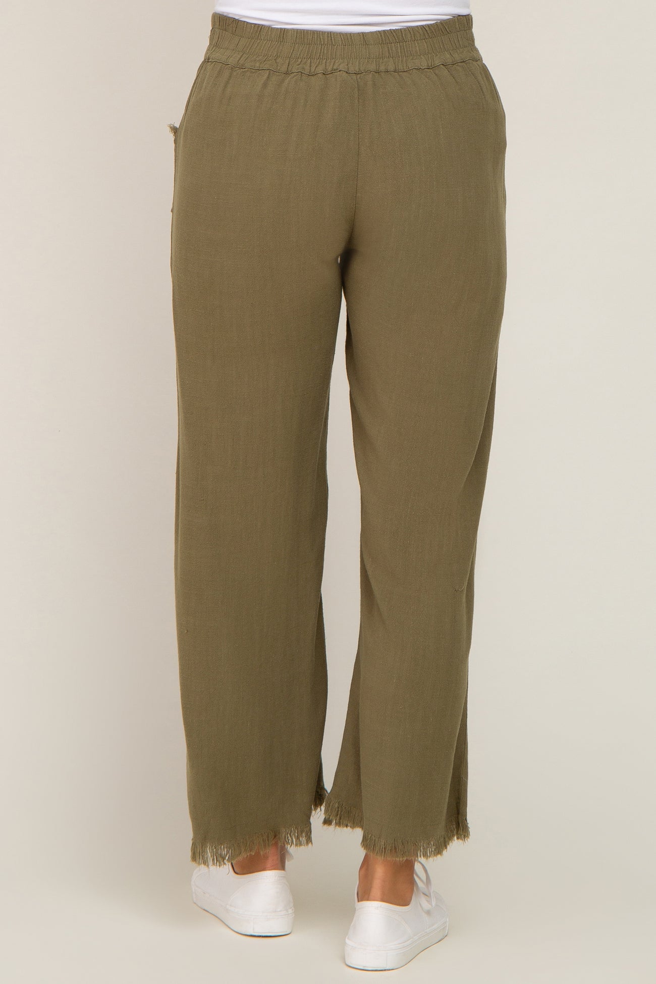 woman wearing olive green maternity wide-leg pants with frayed hem and an elastic waistband