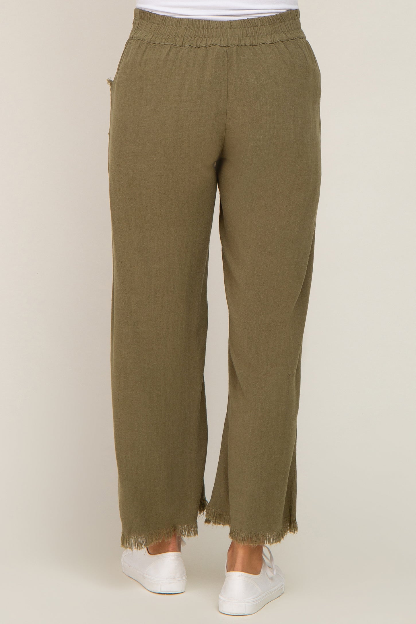woman wearing olive green maternity wide-leg pants with frayed hem and an elastic waistband