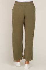 woman wearing olive green maternity wide-leg pants with frayed hem and an elastic waistband