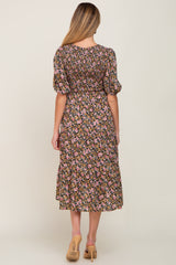 Back view of woman wearing a floral smocked midi dress with puff sleeves and tan heels