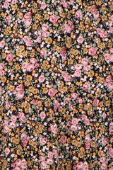 maternity wear featuring a black floral print with pink and yellow flowers on a flowing fabric