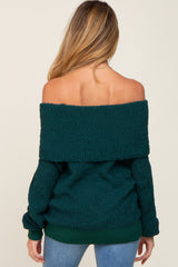 woman wearing a dark green off-the-shoulder maternity sweater with a relaxed fit, shown from the back