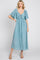 woman wearing a light blue midi dress with flutter sleeves and a tie-front bodice