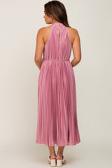 maternity wear long pink pleated dress with a halter neck and a keyhole back detail, model facing away from the camera