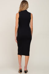 woman wearing a black ribbed midi maternity dress, seen from the back with a fitted silhouette