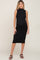 woman wearing a black sleeveless ribbed maternity dress and showing her baby bump
