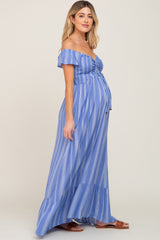 woman wearing a blue and white striped off-the-shoulder maternity maxi dress with a visible baby bump