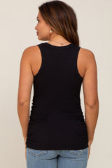 woman wearing a black maternity tank top with side ruching, shown from the back