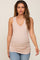woman wearing a light pink maternity tank top with a v-neck and gathered sides, showing her baby bump