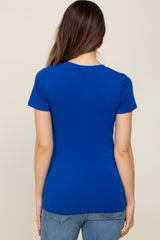 woman wearing a fitted royal blue maternity t-shirt, seen from the back, paired with light blue jeans