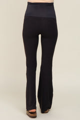 woman wearing black maternity flared leggings with a high waistband, showing the back view