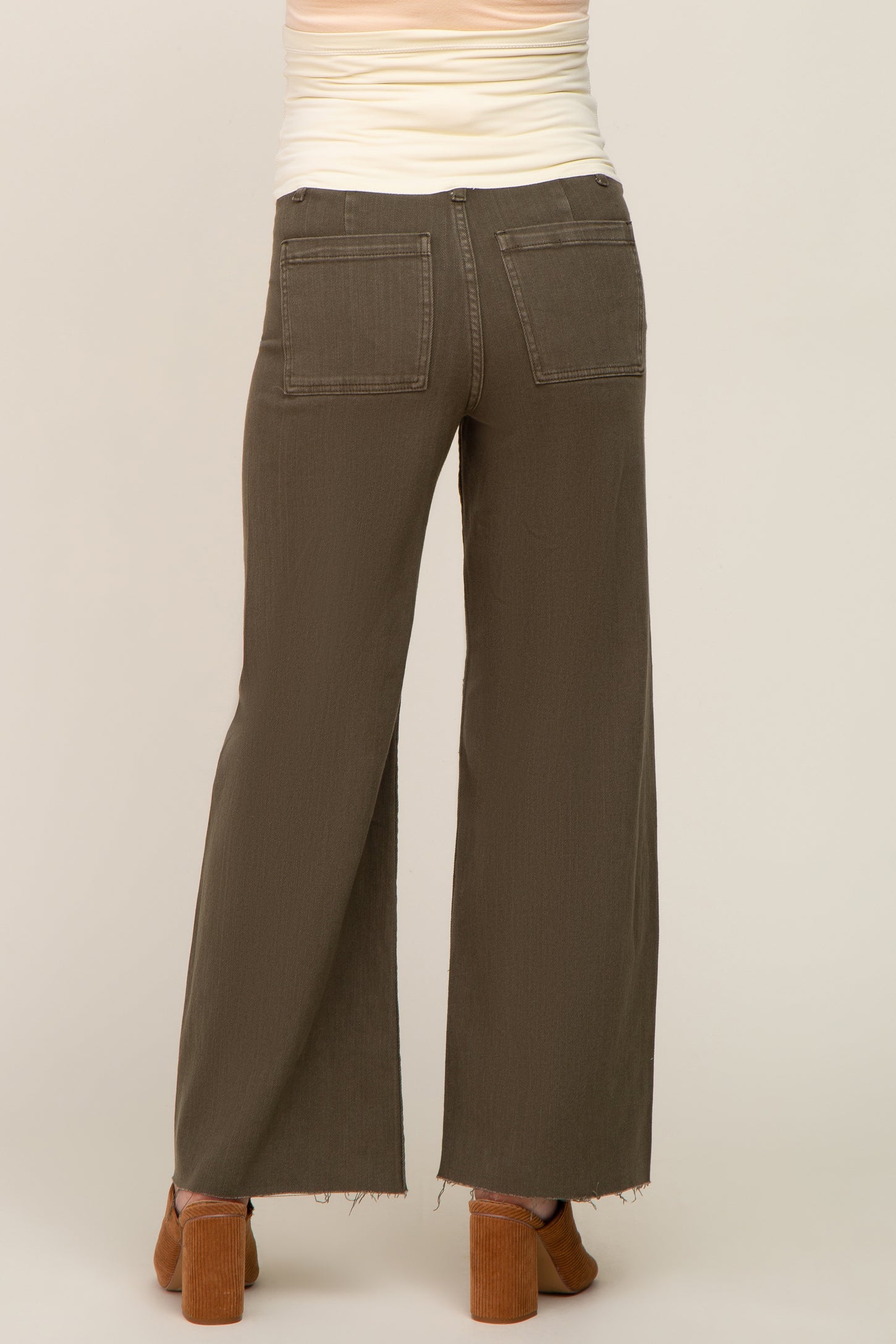 woman wearing olive green maternity wide-leg pants, seen from the back with two pockets visible