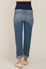 woman wearing a pair of light blue maternity jeans with a dark blue over-the-bump waistband, viewed from the back