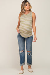 woman wearing a striped olive green maternity tank top and distressed blue jeans, showing her baby bump
