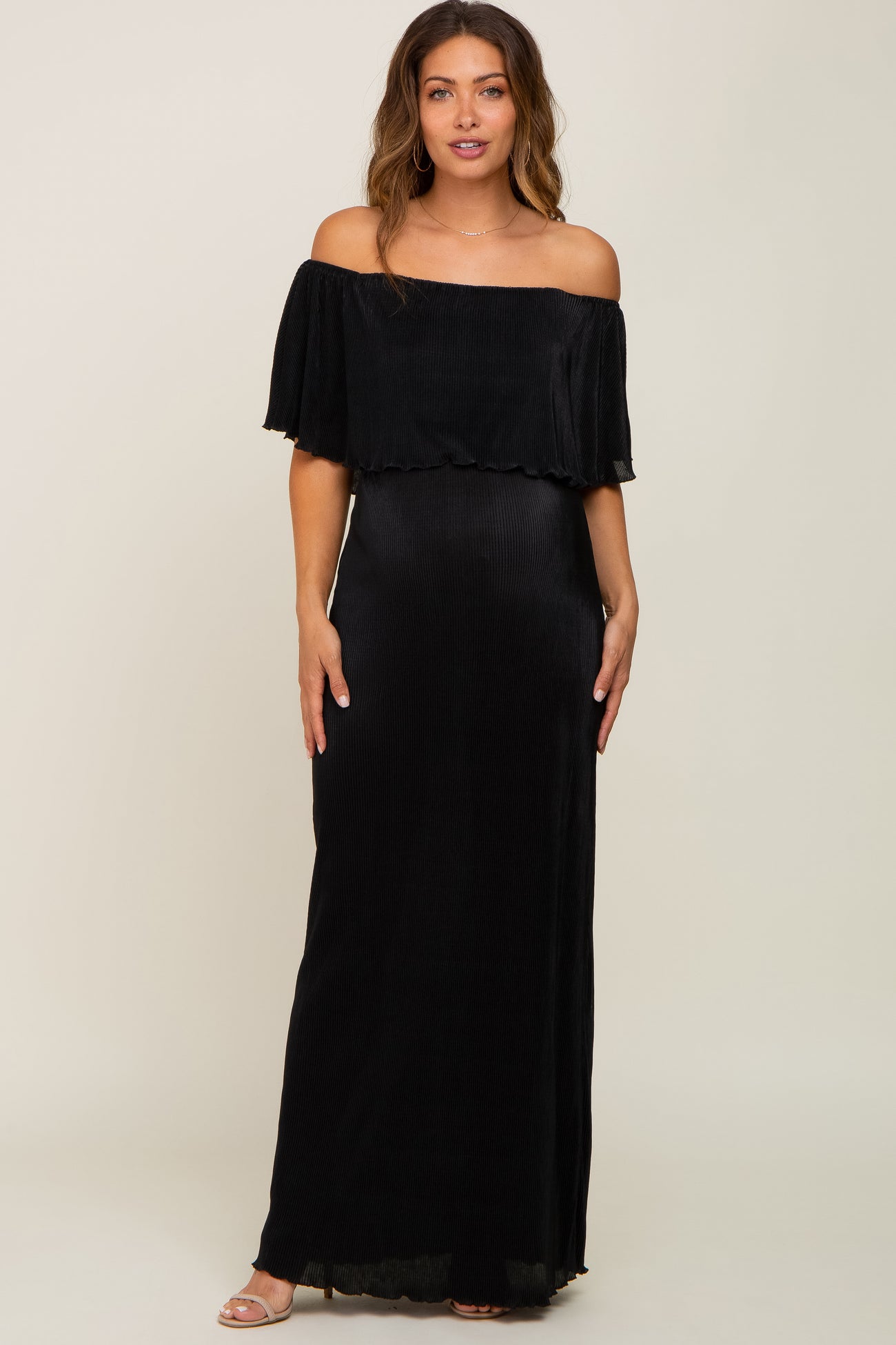 woman wearing a black off-the-shoulder maxi maternity dress with flutter sleeves and a fitted bodice