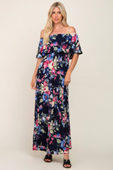 woman wearing a navy off-the-shoulder maxi dress with floral print and flutter sleeves