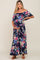 woman wearing a navy floral off-the-shoulder maternity maxi dress and holding her baby bump