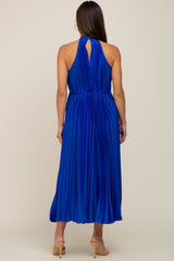 woman wearing a pleated royal blue maternity dress with a keyhole back detail