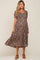 woman wearing a black floral maternity dress with short sleeves and a square neckline, highlighting her baby bump