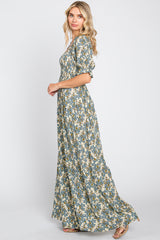 woman wearing a long floral maxi dress with puff sleeves and a cinched waist