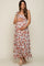 woman wearing a floral print maternity maxi dress and holding her baby bump