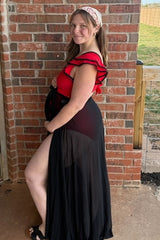 woman wearing a red maternity swimwear with ruffle details and a black sheer cover-up, showing her baby bump