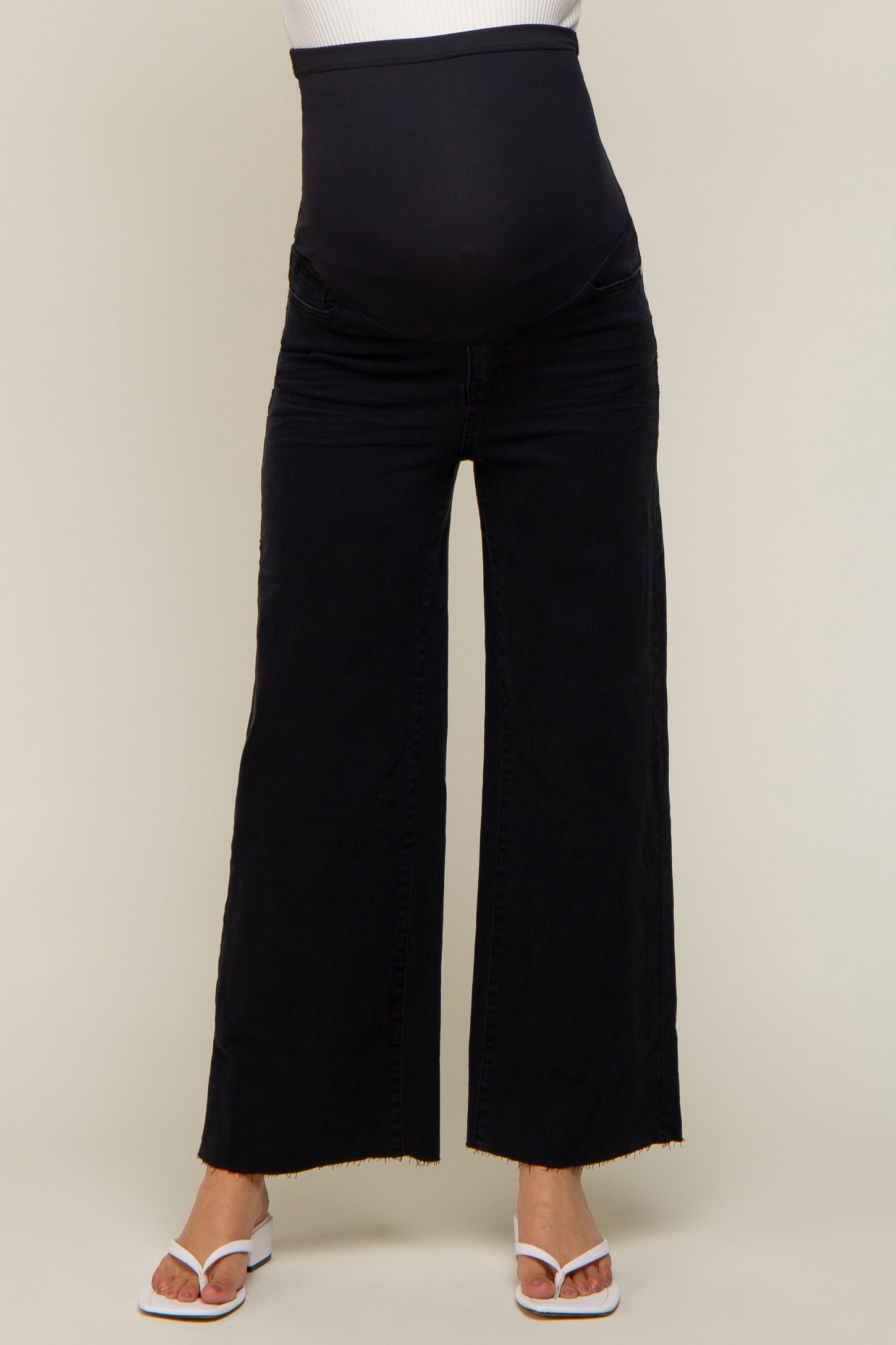 pregnant woman wearing black wide leg maternity jeans with over the belly support band
