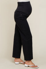 woman wearing black maternity jeans with a supportive belly panel and a baby bump visible