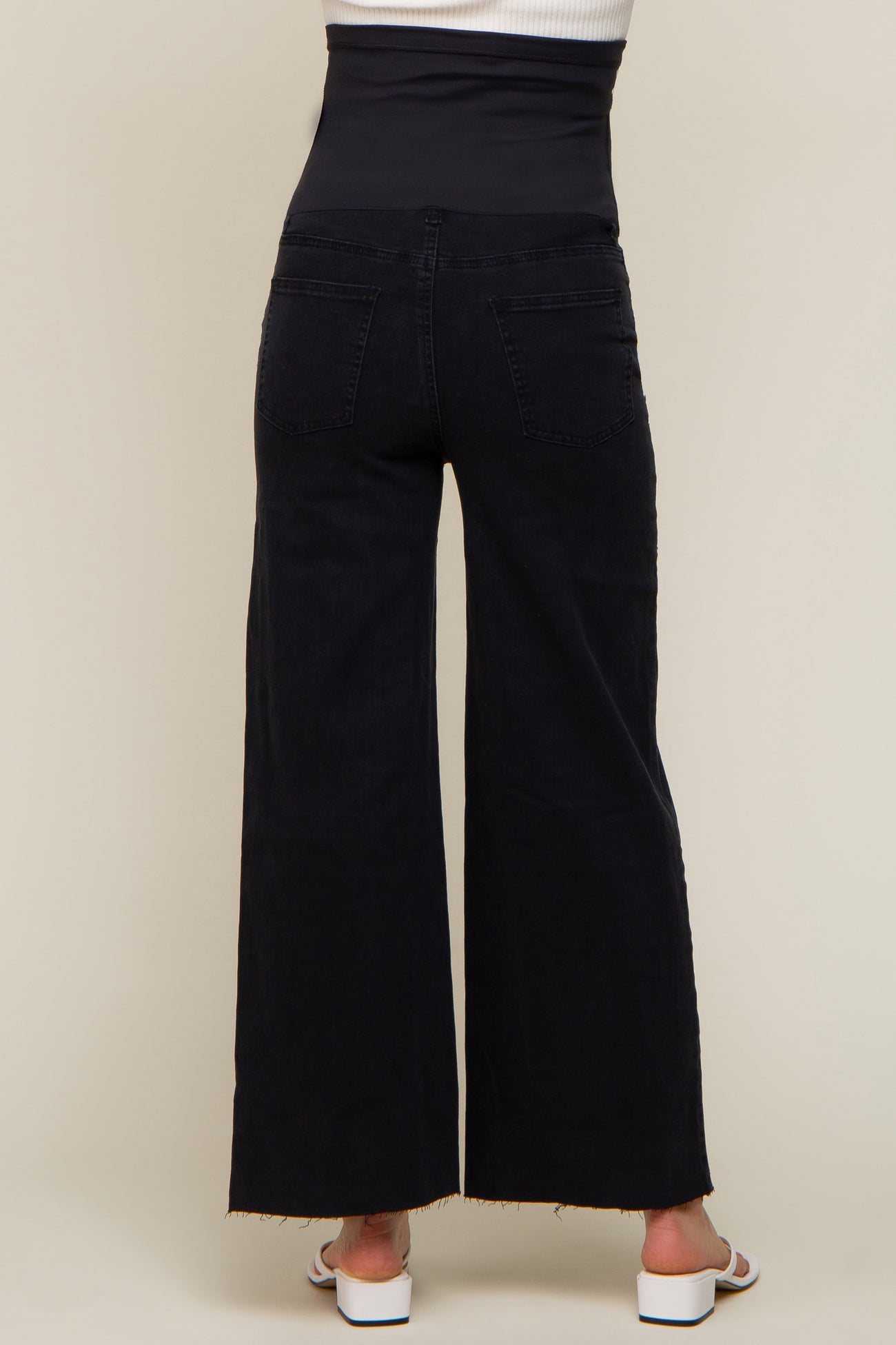 maternity wear black wide leg jeans with a high waistband, styled with a raw hem and no visible baby bump