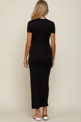 woman wearing a black short sleeve maternity maxi dress, viewed from the back