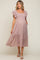 woman wearing a floral print maternity dress with ruffle sleeves and a flowing hem, showcasing her baby bump