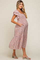 maternity wear floral midi dress with ruffled sleeves and pockets, model showcasing a visible baby bump