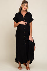 woman wearing a black button-up maternity dress with rolled sleeves and a side slit, showing her baby bump