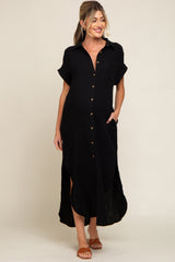 woman wearing a black short sleeve button-up maternity dress with a relaxed fit and side slits