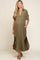woman wearing an olive green maternity button-up dress with short sleeves and side pockets, showcasing her baby bump