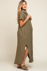 woman wearing an olive green short sleeve maternity maxi dress with a split side and showing her baby bump