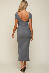 woman wearing a grey maternity maxi dress with a deep back and short sleeves