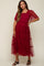 woman wearing a red tiered tulle maternity dress with puff sleeves and a square neckline